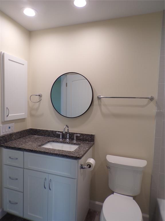 3112 Pinetree Street Port Charlotte, FL 33952 - Photo 20 of 35 a bathroom with a granite countertop toilet sink and mirror