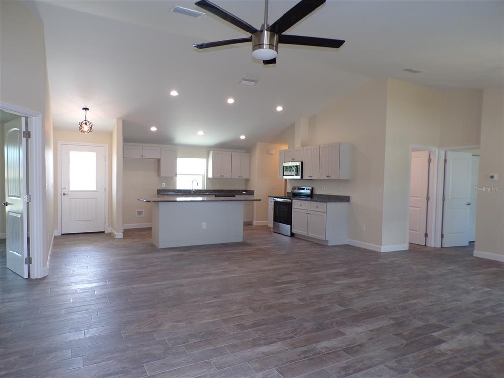 3112 Pinetree Street Port Charlotte, FL 33952 - Photo 2 of 35 a view of kitchen with kitchen island a sink wooden floor and stainless steel appliances