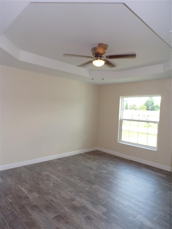 3112 Pinetree Street Port Charlotte, FL 33952 - Photo 27 of 35 wooden floor in an empty room with a window