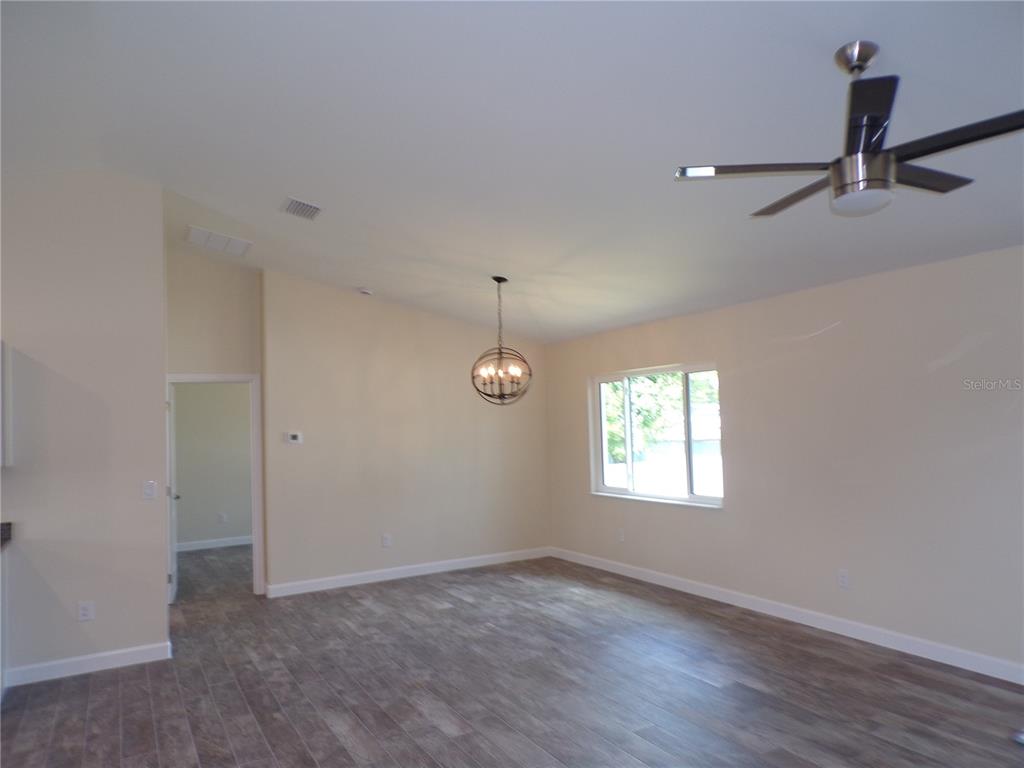 3112 Pinetree Street Port Charlotte, FL 33952 - Photo 30 of 35 wooden floor in an empty room with a window