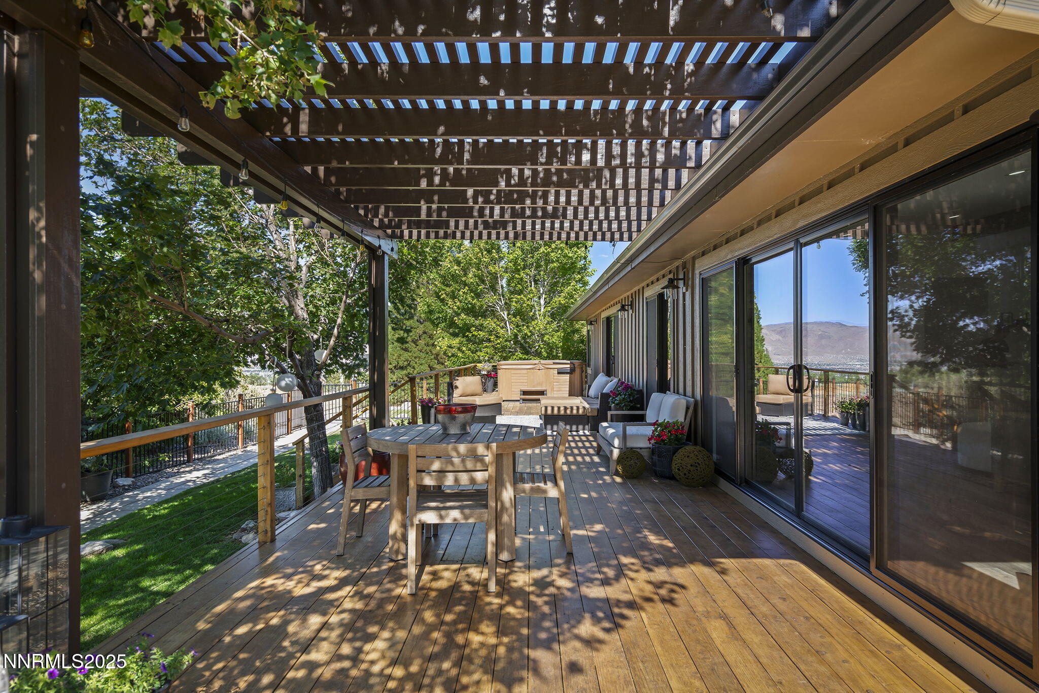 2505 Trails End Lane Reno, NV 89511 - Photo 23 of 45 a view of a patio with table and chairs potted plants and floor to ceiling window