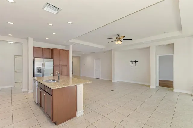 a kitchen with stainless steel appliances granite countertop a sink stove and cabinets