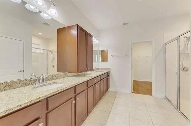 a bathroom with a shower and a glass door