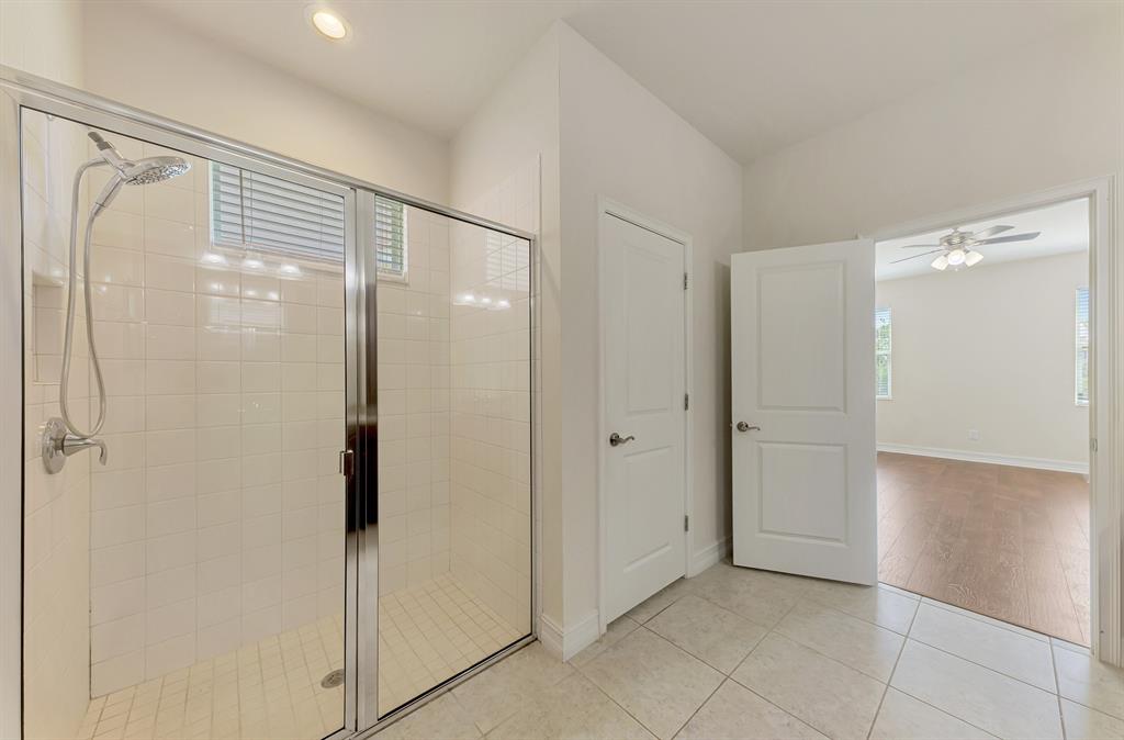 4429 Conchfish Lane Osprey, FL 34229 - Photo 24 of 39 a bathroom with a shower and a glass door