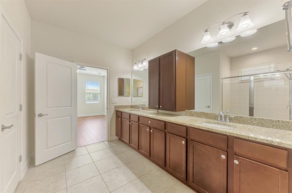 4429 Conchfish Lane Osprey, FL 34229 - Photo 25 of 39 a spacious bathroom with a granite countertop sink a mirror and a shower