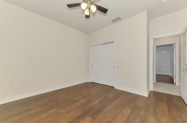 a bathroom with a granite countertop sink a toilet and shower