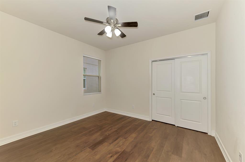 4429 Conchfish Lane Osprey, FL 34229 - Photo 30 of 39 an empty room with wooden floor chandelier fan and windows