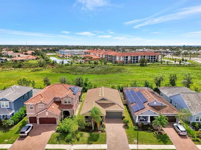 an aerial view of a house with big yard