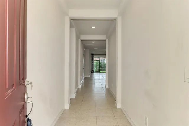 a view of a hallway with wooden shelves