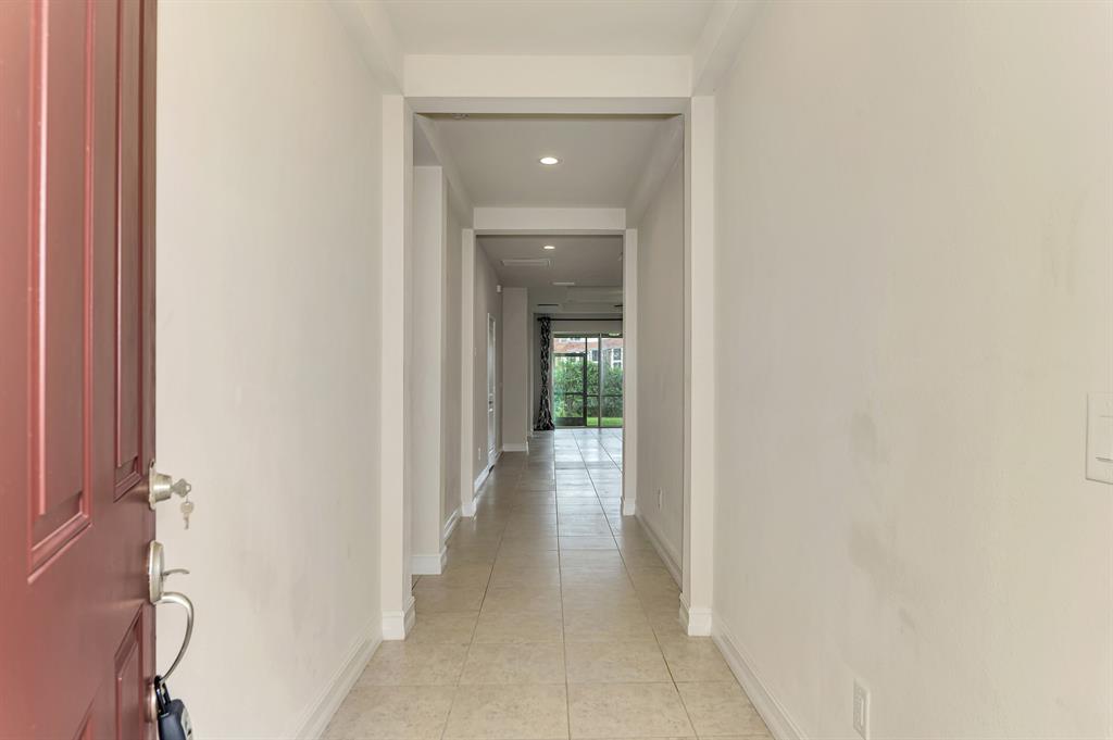 4429 Conchfish Lane Osprey, FL 34229 - Photo 5 of 39 a view of a hallway with wooden shelves