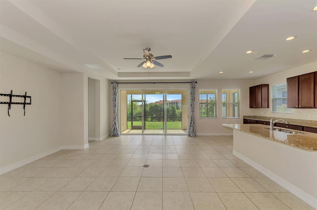 4429 Conchfish Lane Osprey, FL 34229 - Photo 10 of 39 a large white kitchen with granite countertop a large window and a sink