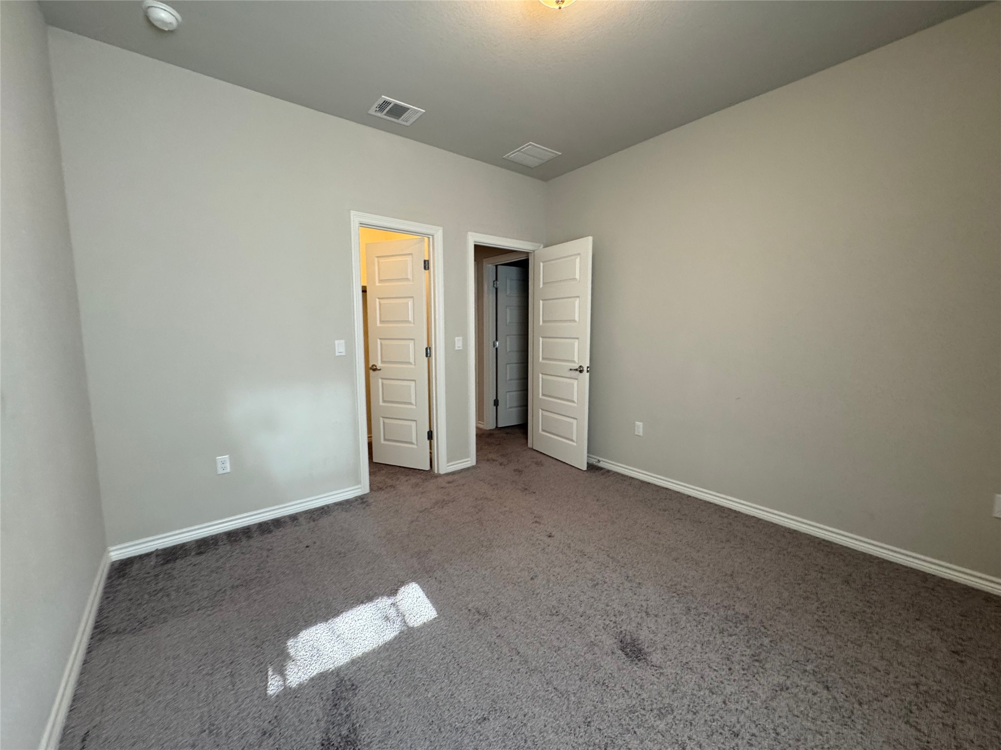 14100 McCoy Loop, Unit 1 Austin, TX 78717 - Photo 30 of 39 A spacious bedroom featuring plush carpet flooring and clean, unadorned walls ready for personalization.