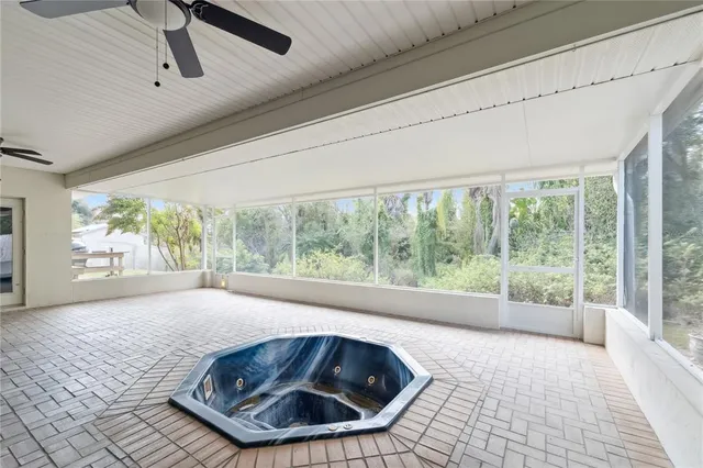 a room with a bed and large window