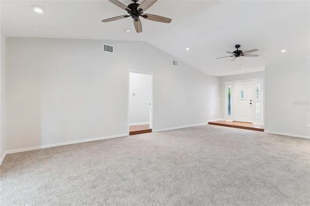 an empty room with a ceiling fan