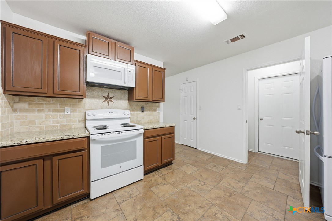 6525 Brooks Drive Temple, TX 76502 - Photo 16 of 37 a kitchen with a sink stove and cabinets