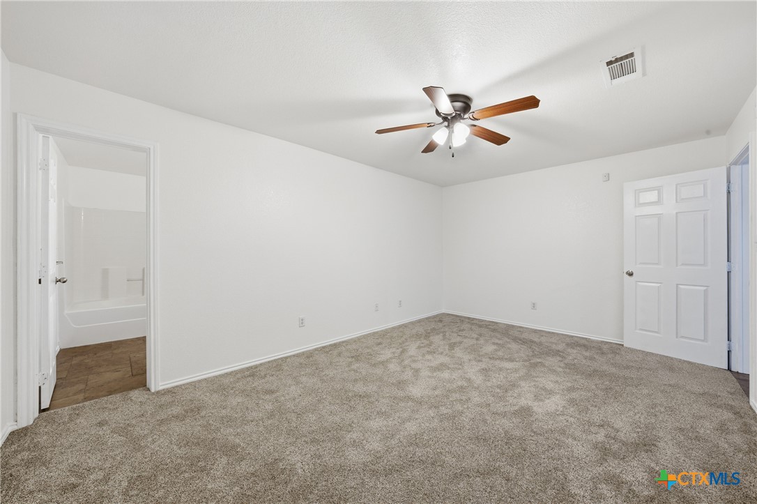 6525 Brooks Drive Temple, TX 76502 - Photo 21 of 37 an empty room with closet and a ceiling fan