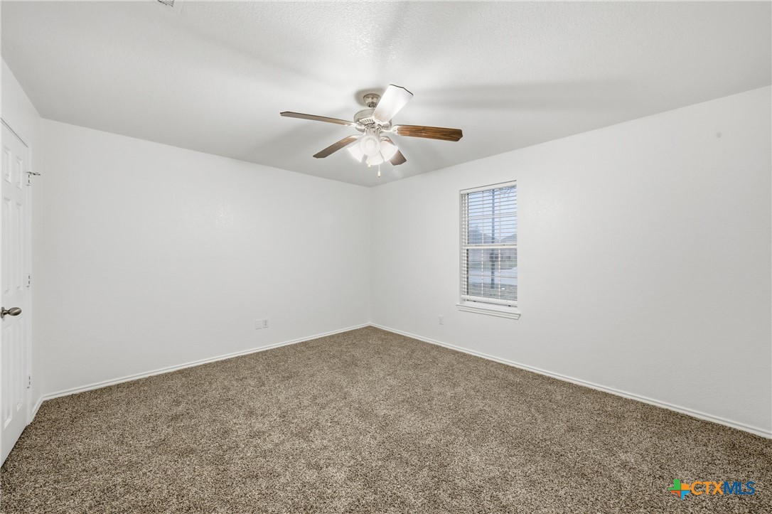 6525 Brooks Drive Temple, TX 76502 - Photo 25 of 37 a view of an empty room with a ceiling fan and window