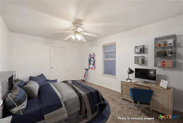 a bed room with a bed and a television