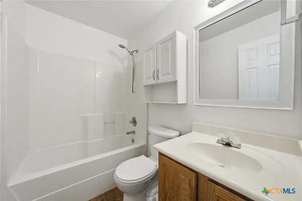 a bathroom with a sink toilet vanity and shower