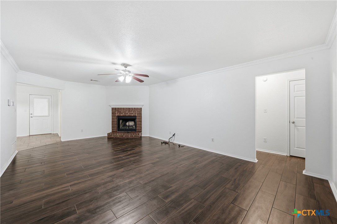 6525 Brooks Drive Temple, TX 76502 - Photo 5 of 37 a view of a livingroom with wooden floor and a ceiling fan