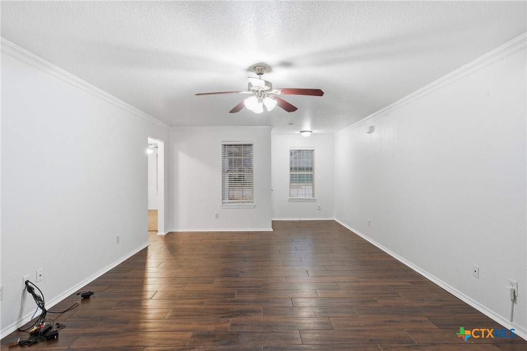 6525 Brooks Drive Temple, TX 76502 - Photo 10 of 37 a view of an empty room with window and wooden floor