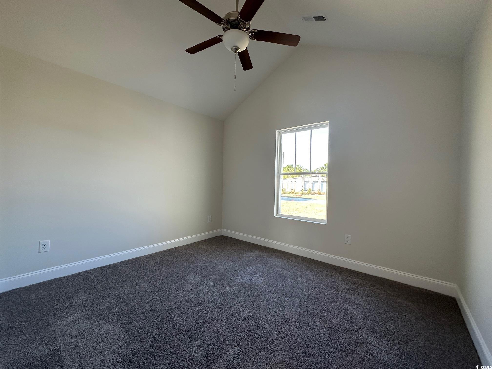 1248 Wehler Court Conway, SC 29526 - Photo 12 of 24 Spare room featuring visible vents, high vaulted ceiling, dark carpet, baseboards, and ceiling fan