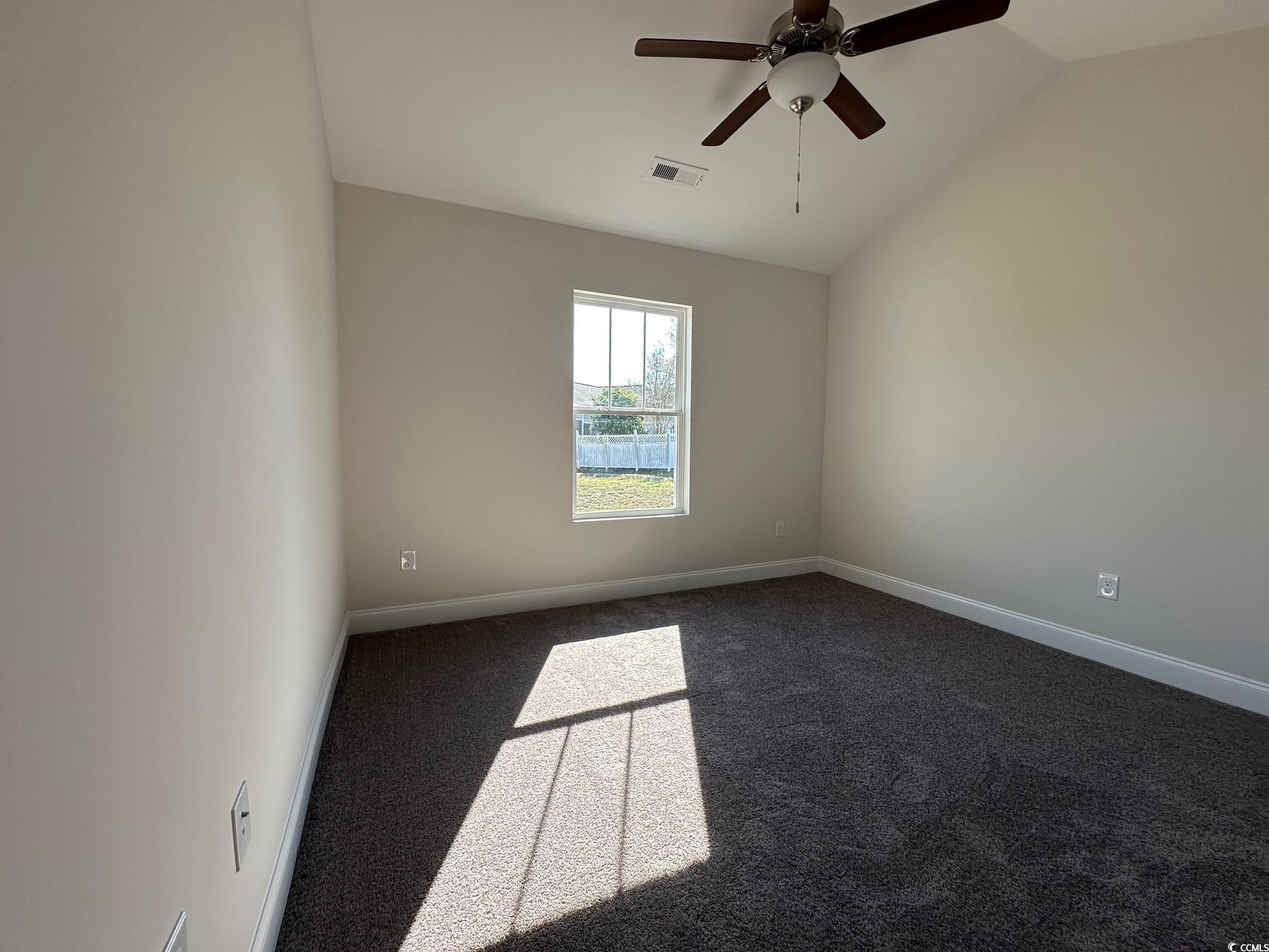 1248 Wehler Court Conway, SC 29526 - Photo 15 of 24 Empty room with baseboards, visible vents, ceiling fan, vaulted ceiling, and dark colored carpet