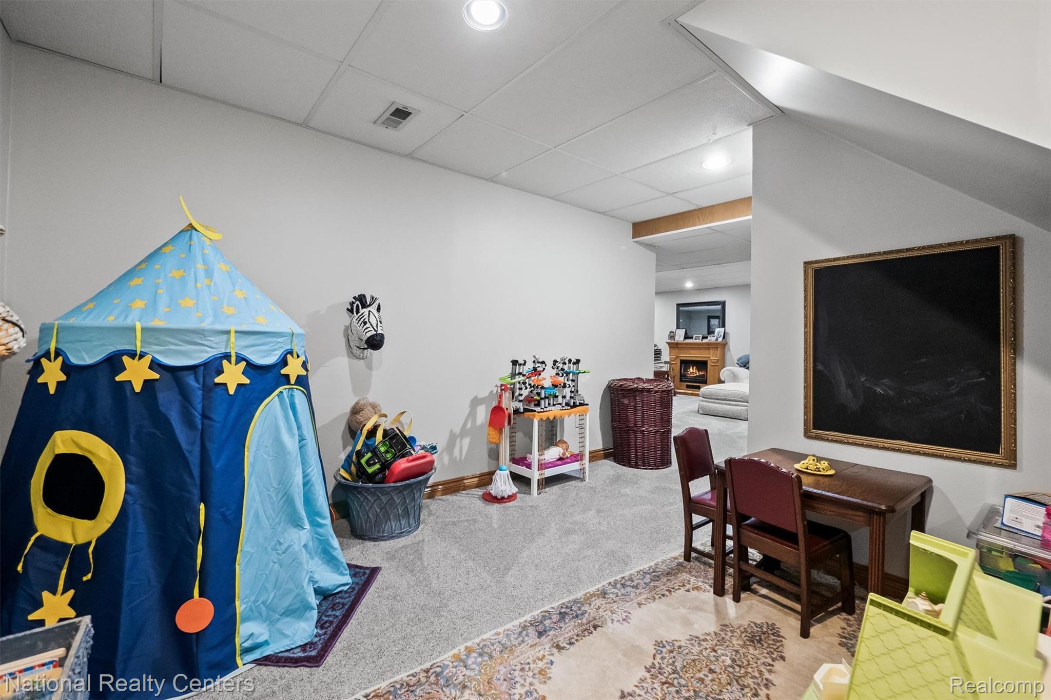 2203 Rochelle Park Drive Rochester, MI 48309 - Photo 36 of 43 Carpeted lower level featuring recessed lighting, a drop ceiling, and a distinct chalkboard wall