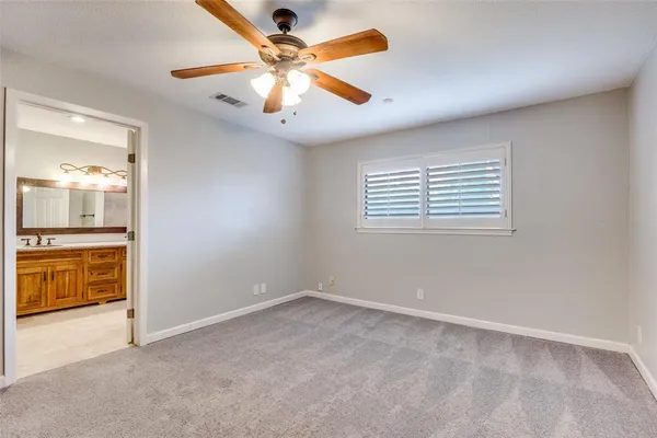 an empty room with a bathroom and a sink