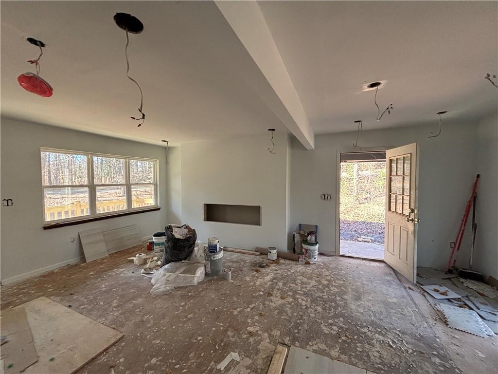 1209 Pebblebrook Road Southeast Mableton, GA 30126 - Photo 18 of 24 a room with a couch a dining table chairs and windows