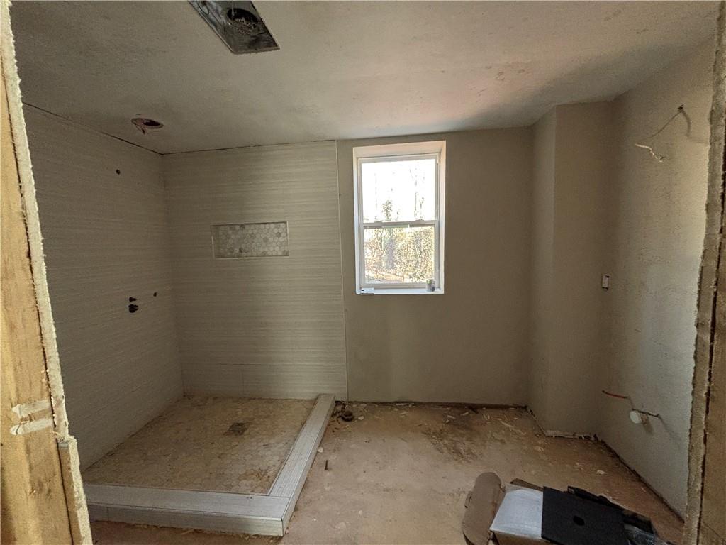 1209 Pebblebrook Road Southeast Mableton, GA 30126 - Photo 20 of 24 an empty room with a empty space and windows