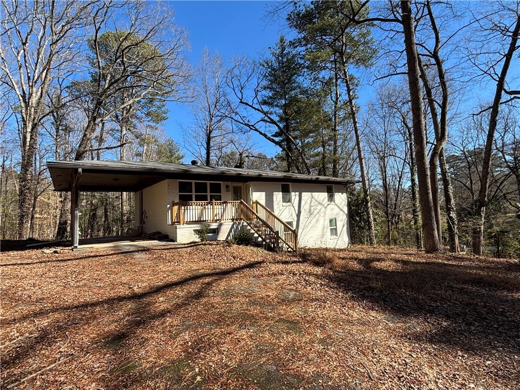 1209 Pebblebrook Road Southeast Mableton, GA 30126 - Photo 2 of 24 a view of a house with a large tree and a yard