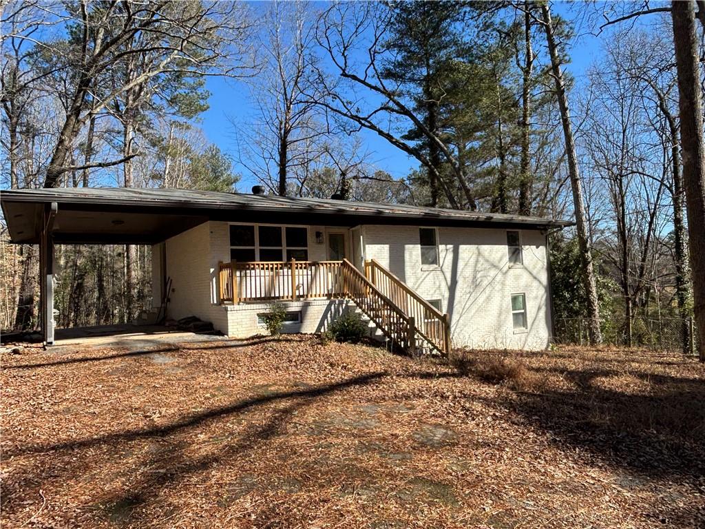 1209 Pebblebrook Road Southeast Mableton, GA 30126 - Photo 4 of 24 a view of a house with a large tree and a yard