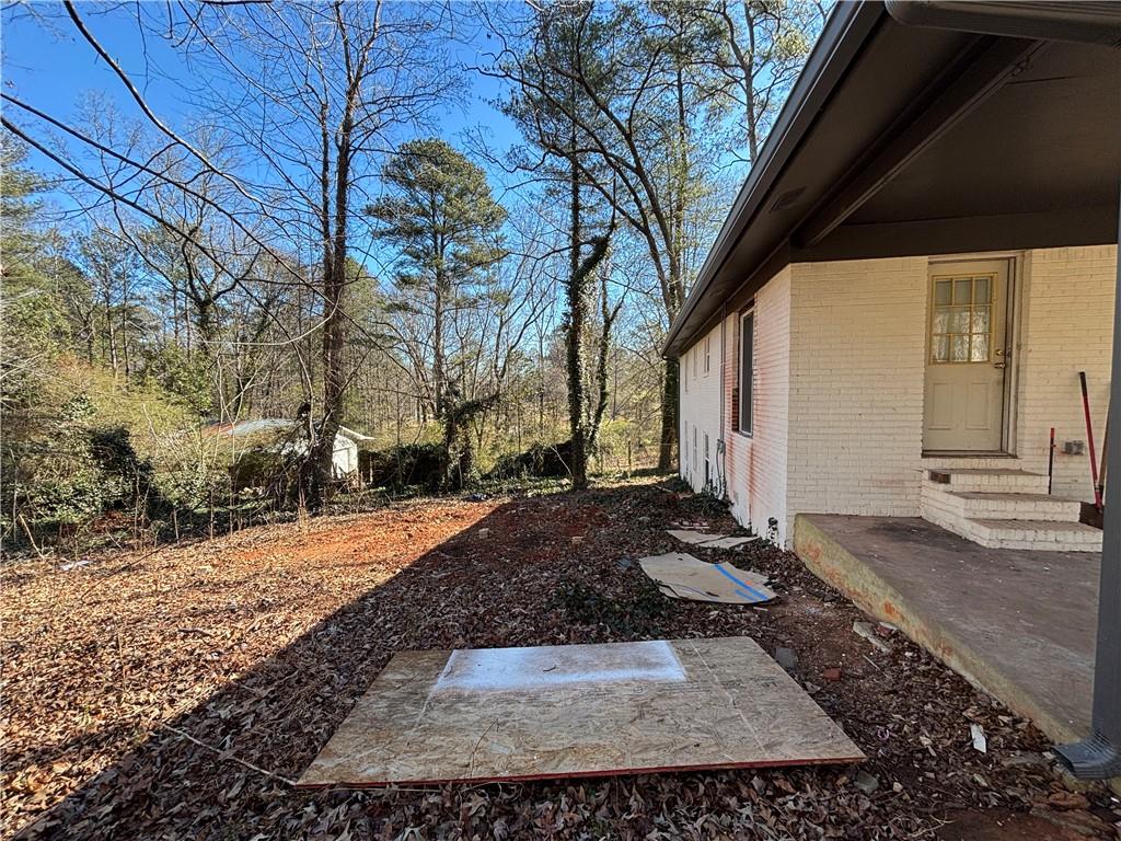 1209 Pebblebrook Road Southeast Mableton, GA 30126 - Photo 5 of 24 a view of a backyard with large trees