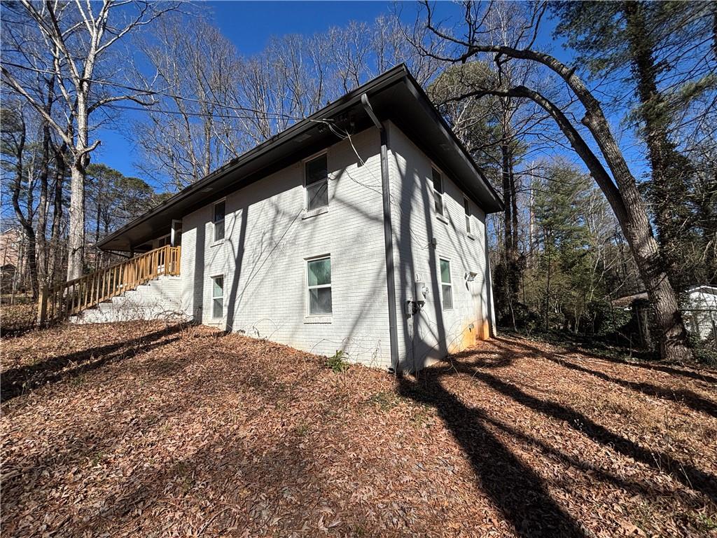 1209 Pebblebrook Road Southeast Mableton, GA 30126 - Photo 7 of 24 a backyard of a house with large trees