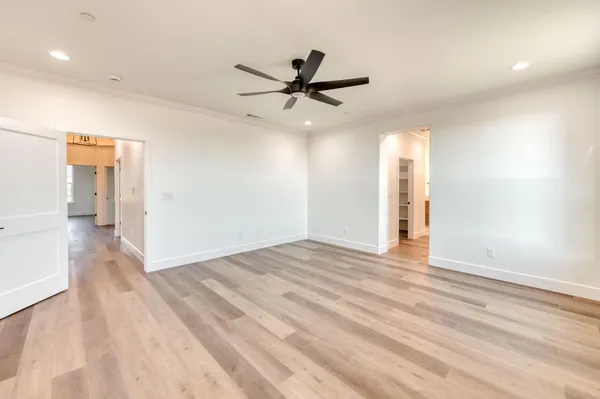 a view of walk in closet with empty racks
