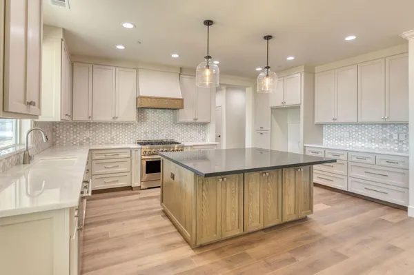 a spacious bathroom with a granite countertop sink a toilet and shower