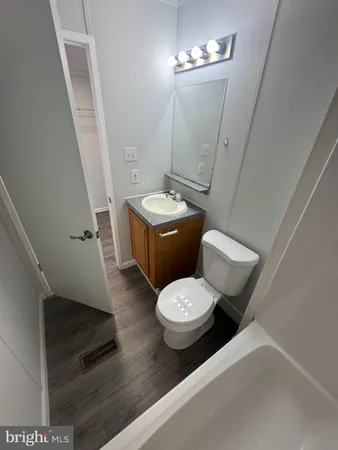 a white toilet sitting next to a bath tub