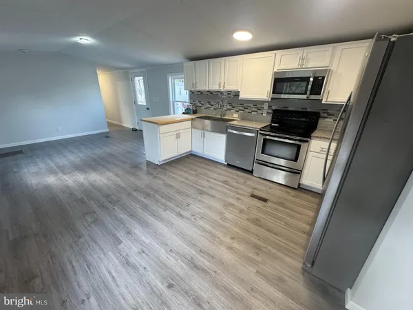a kitchen with a sink stainless steel appliances and cabinets