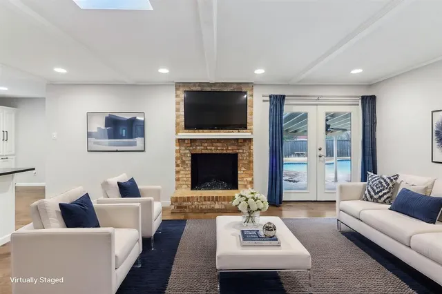 a living room with furniture wooden floor and a fireplace