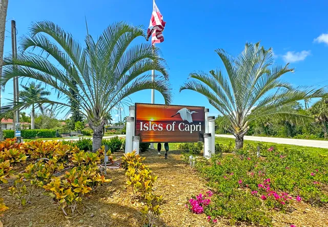 a sign that is sitting in front of flowers