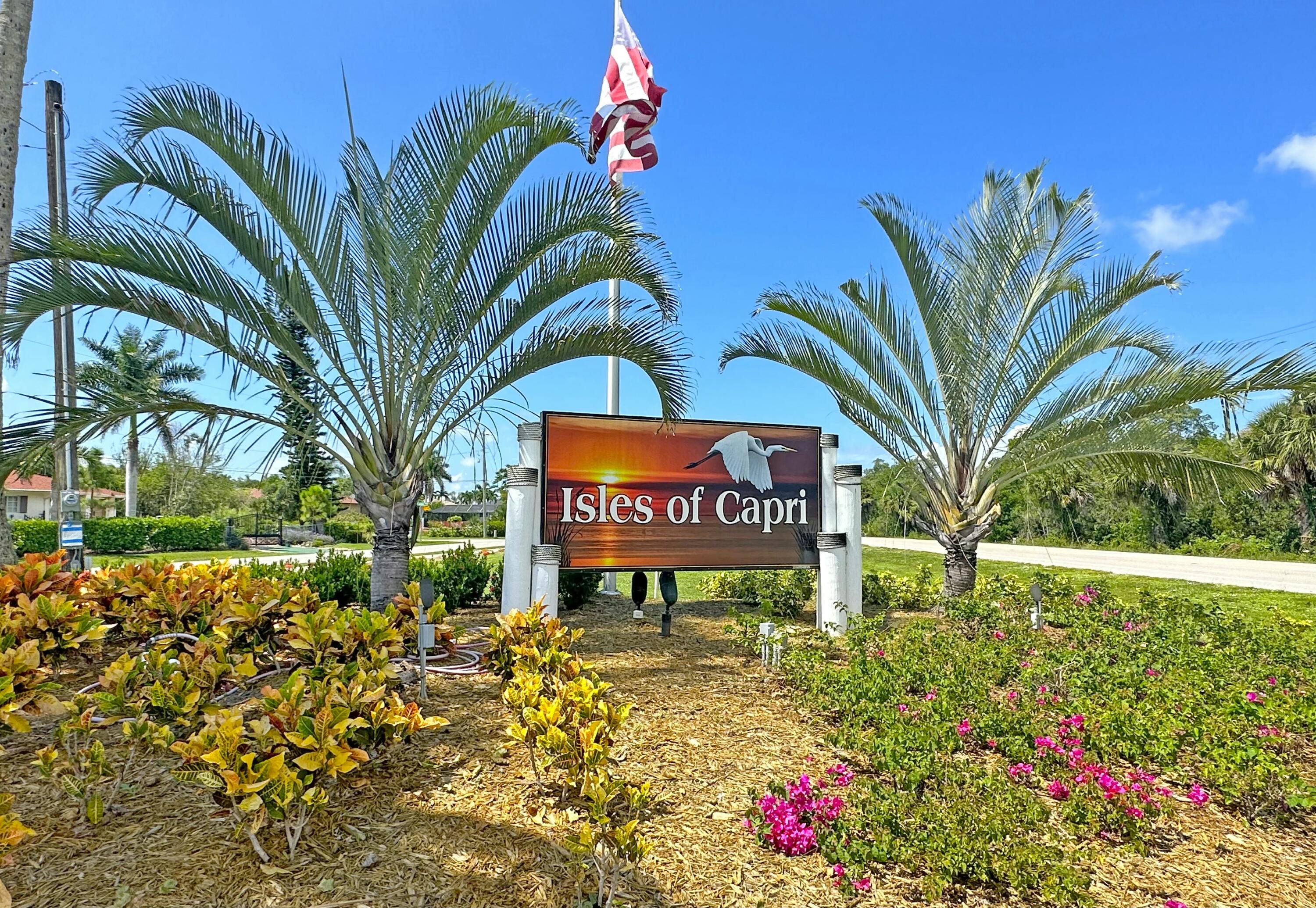 147 Capri Boulevard Naples, FL 34113 - Photo 14 of 21 a sign that is sitting in front of flowers