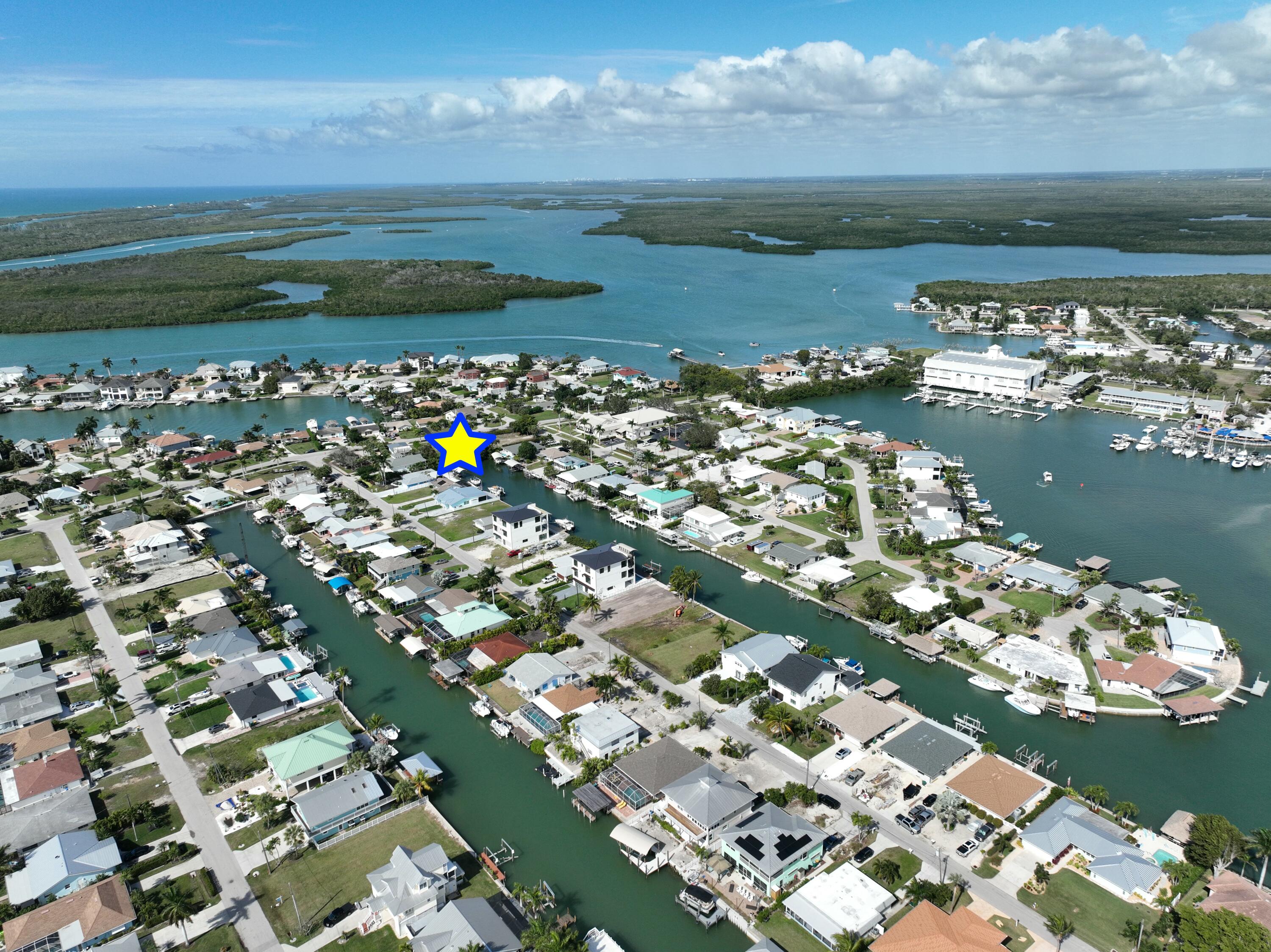 147 Capri Boulevard Naples, FL 34113 - Photo 5 of 21 a view of a lake with a city