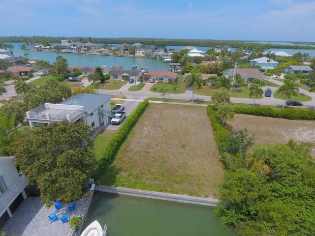 an aerial view of a residential houses with outdoor space and swimming pool