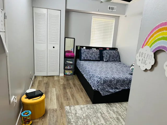 a living room with a couch and a wooden floor