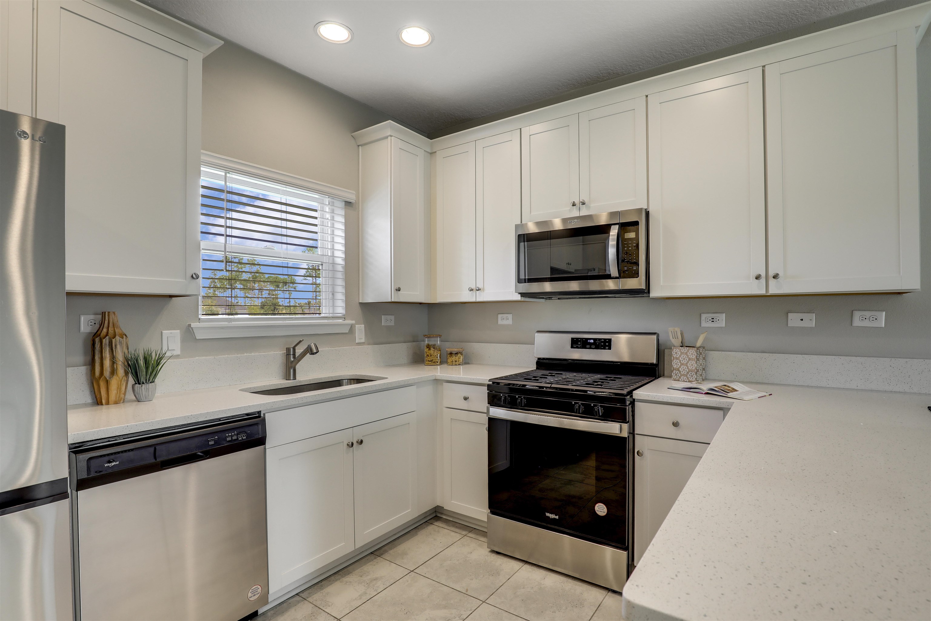 333 Bermudez Way St. Augustine, FL 32095 - Photo 15 of 62 a kitchen with granite countertop white cabinets white appliances and a sink
