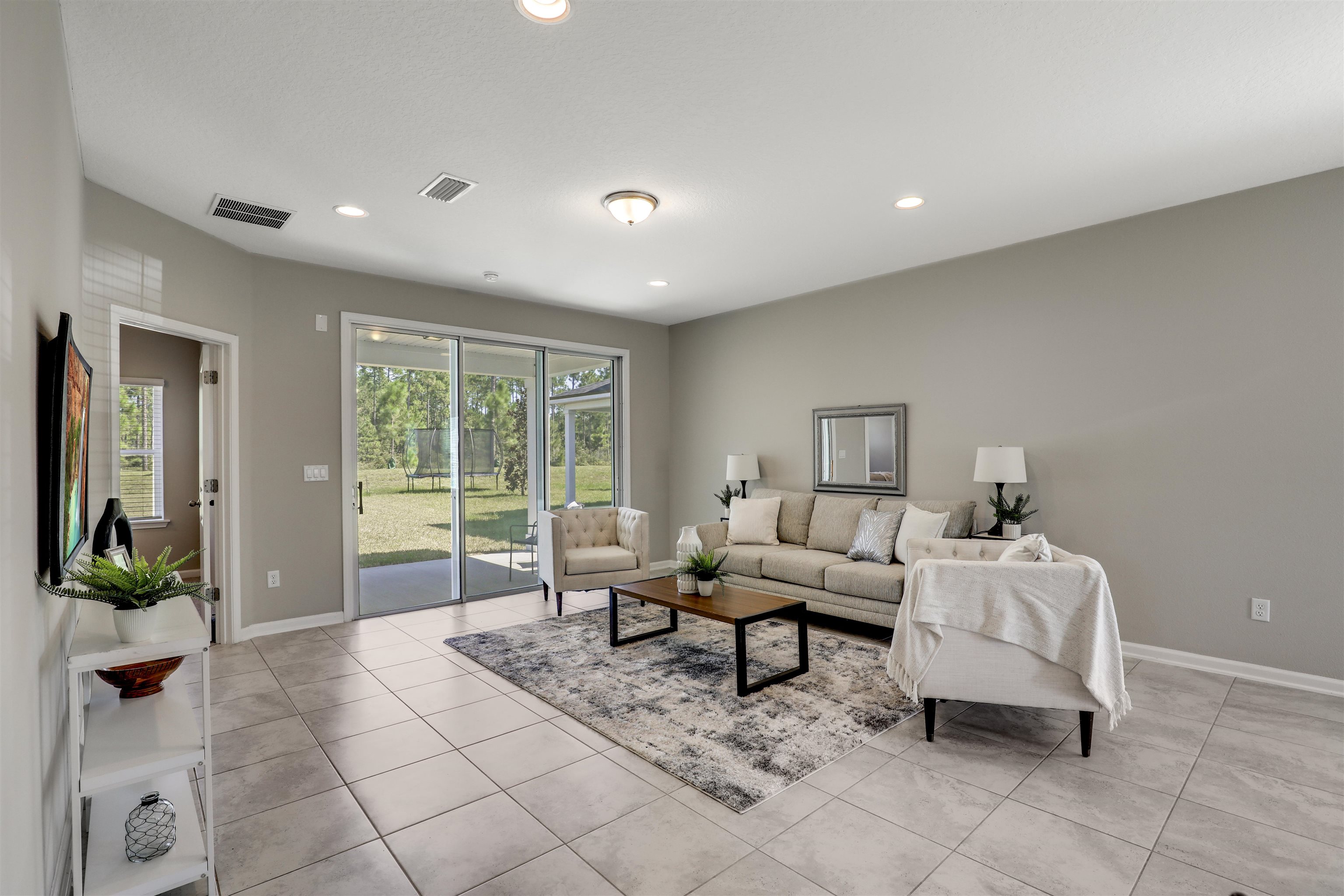 333 Bermudez Way St. Augustine, FL 32095 - Photo 19 of 62 a living room with furniture and a floor to ceiling window