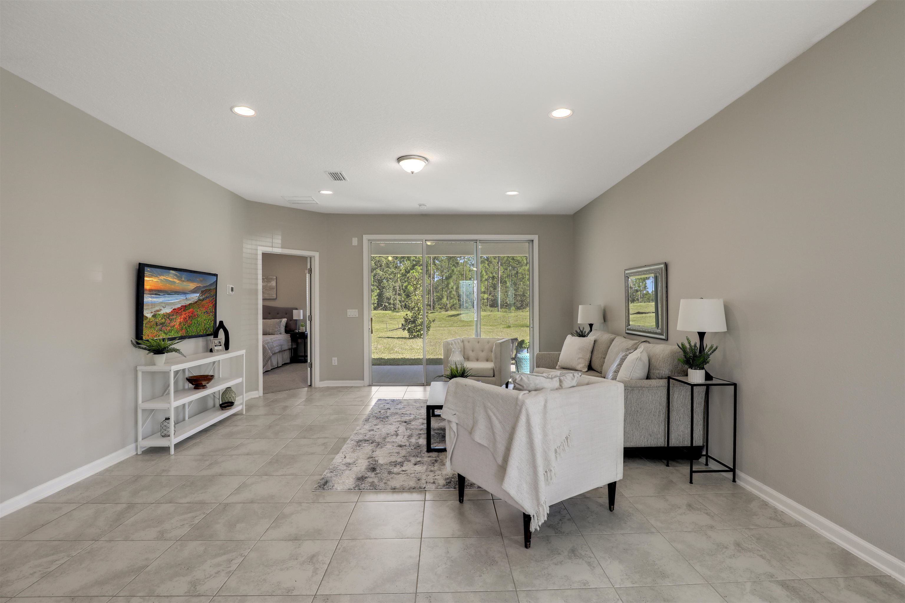 333 Bermudez Way St. Augustine, FL 32095 - Photo 20 of 62 a spacious bedroom with a bed and a flat screen tv