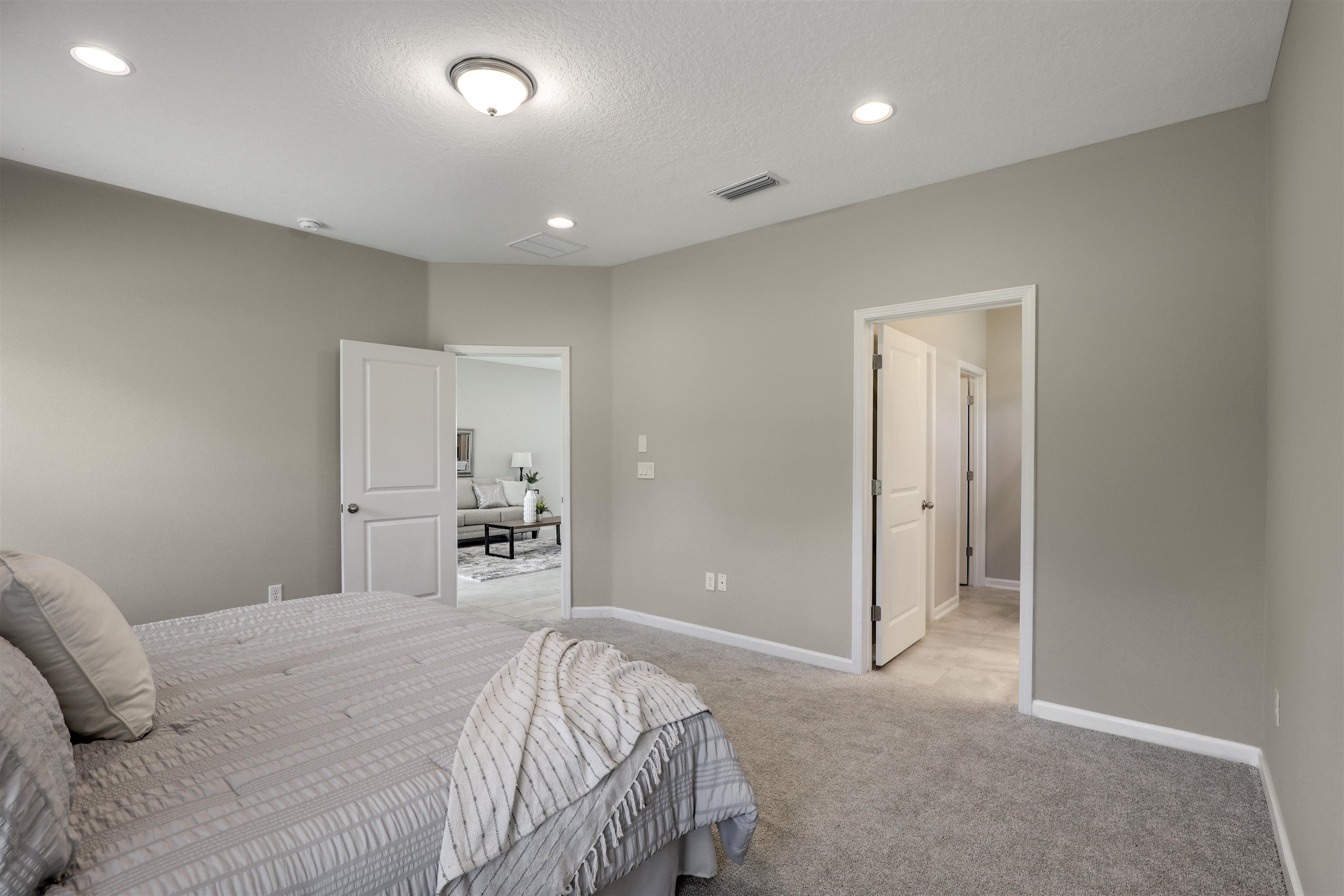 333 Bermudez Way St. Augustine, FL 32095 - Photo 24 of 62 a bedroom with a large bed and a chandelier