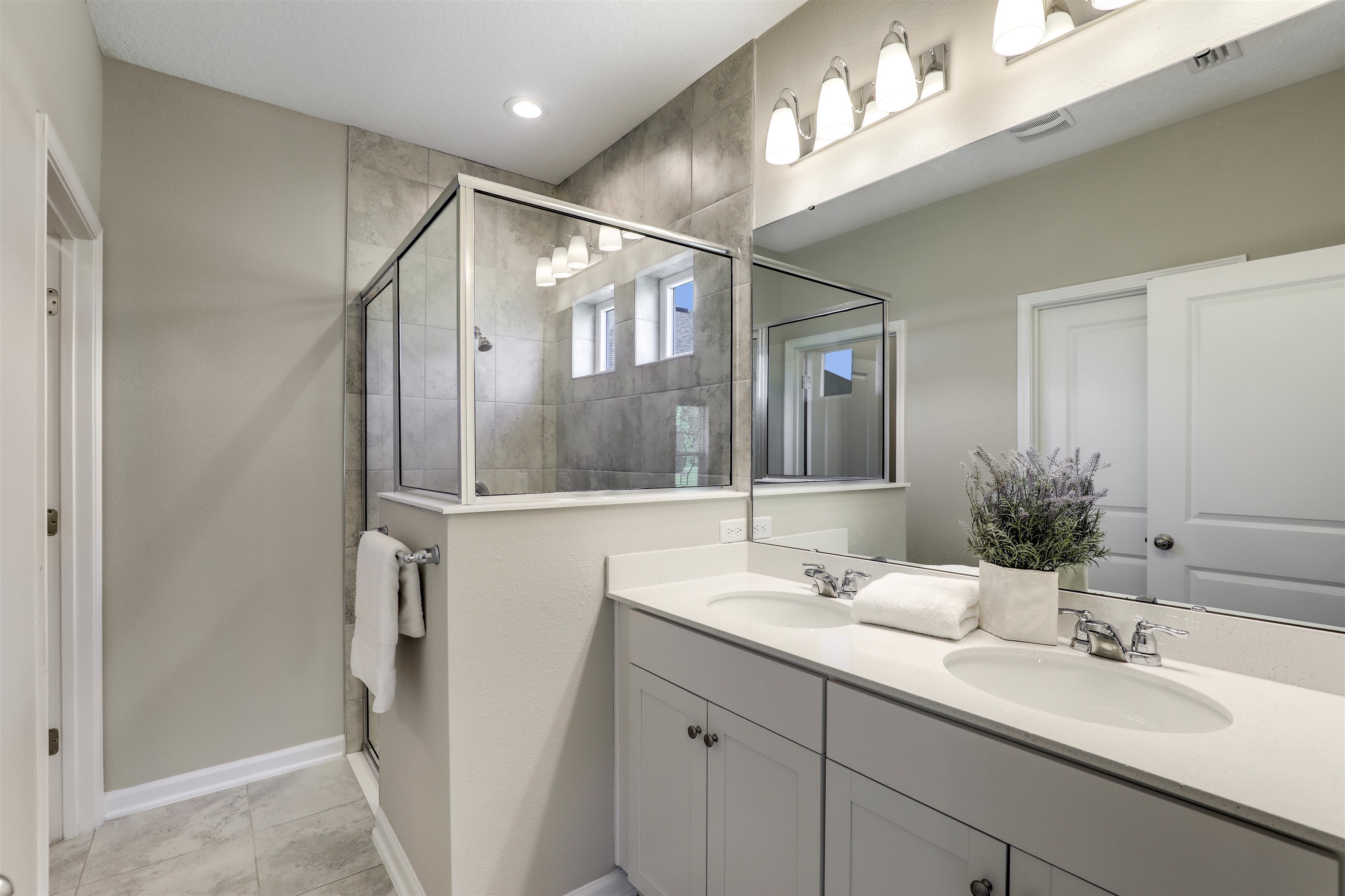 333 Bermudez Way St. Augustine, FL 32095 - Photo 25 of 62 a bathroom with a double vanity sink and a mirror